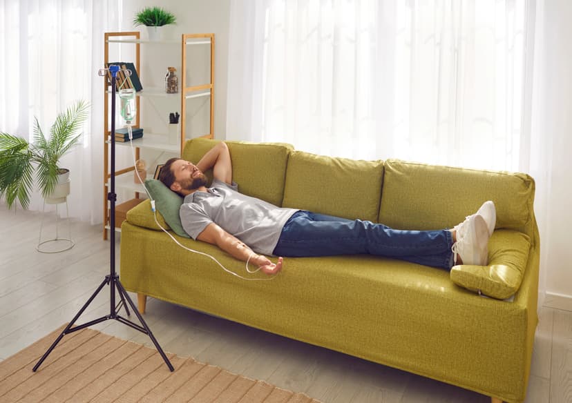 Man lying down enjoy his IV treatment.