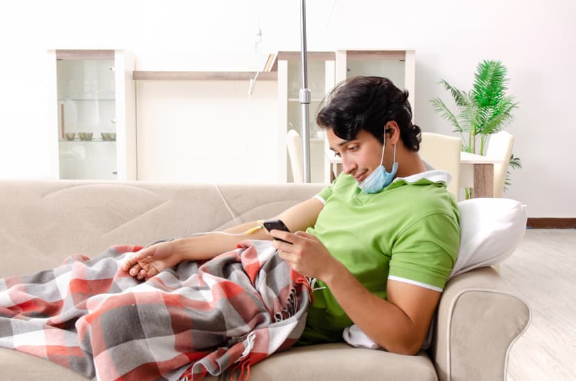 Man laying on couch getting mobile IV drip.